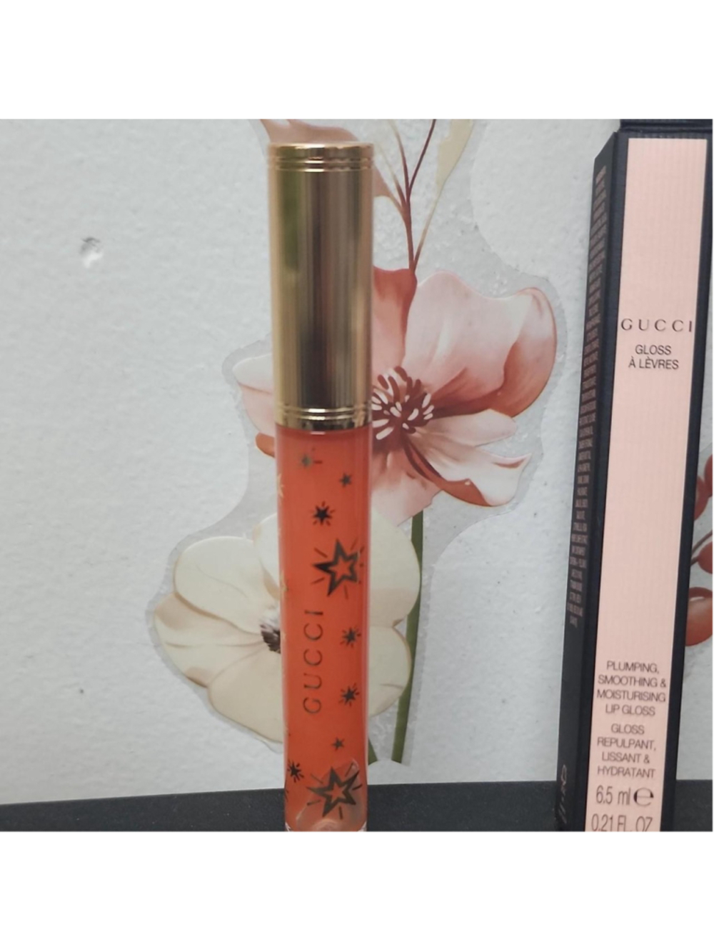 Gucci lip gloss in shade 314 Sade Coral